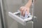 Cleaning glass door handles with an antiseptic wet wipe. Woman hand using towel for cleaning home room door link