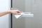 Cleaning glass door handles with an antiseptic wet wipe. Woman hand using towel for cleaning home room door link