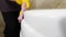 Cleaning in hotel or apartament. Pretty maid from hotel staff cleaning washing sink with a rag. wiping bathtub in