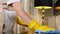 Cleaning in hotel. Close-up shot of young woman housekeeper in apron cleaning, wiping table surface with microfiber