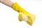 Cleaning the house and sanitation topic: Hand holding a yellow sponge wet with foam isolated on a white background in studio