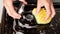 Cleaning the kitchen, appliances, cleaning the surface on the gas stove, burner cleaning yellow washcloth close-up