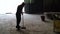 A cleaning lady sweeping an industrial room. Industrial garbage collection. Slow motion.