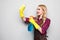 Cleaning lady. Woman cleaning scrubbing and polishing reaching and stretching with cleaning cloth and spray bottle.