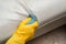 Cleaning leather sofa at home with towel