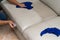 Cleaning leather sofa with sponge and towel