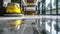 Cleaning machine in empty office lobby, shiny clean marble floor and yellow vacuum equipment in building hall. Concept of