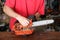 Cleaning and maintenance of the chainsaw by a person on a table