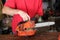 Cleaning and maintenance of the chainsaw by a person on a table