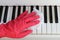 Cleaning a musical instrument to eliminate germs,Covid-19. Female hands in protective gloves cleaning the piano keys