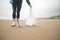 Cleaning the ocean coast from debris. A volunteer carries a bag of rubbish that he removed from the ocean shore. Pure light sand.