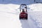 Cleaning the path from the snow with a snowplow