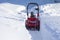 Cleaning the path from the snow with a snowplow