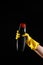 Cleaning products, black rust remover in hands with yellow rubber gloves