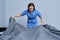 Cleaning service in hotel room, woman maid preparing guest room making bed