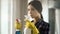 Cleaning service lady holding sprays for glass window surface, sanitizing room