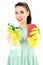 Cleaning service and work concept. Woman winks and holds sponge and household spray.