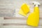 Cleaning Set. Yellow tools for cleaning. Cleaning spray with sponge on light background