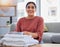 Cleaning, smile and laundry with portrait of woman in living room for housekeeping service, clothes and fabric