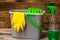 Cleaning sprayer anti bacterial sanitizer spray isolated with mop bucket and yellow gloves, concept of infection control.  Plastic