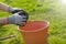 Cleaning spring garden. Harvesting leaves in the garden in the spring season.Hands in gloves fold autumn leaves in a