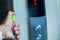 Cleaning staff Cleaned elevator switch button with alcohol spray in hospital or building office or condominium