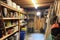 cleaning supply closet, fully stocked with mops, brooms and cleaning products