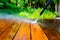 Cleaning the terrace with a pressure washer - high-pressure cleaner on the wooden surface of the terrace - very shallow depth of