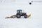 Cleaning tractor snowballed football field