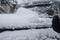 Cleaning the trunk of the car from the snow brush.