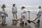 cleaning up oil spills on the beaches of lima with the repsol company in lima peru in the year 2022