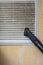 Cleaning ventilation grill with vacuum cleaner