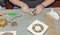 Cleaning a very dirty kitchen exhaust fan from dirt with a brush. A man cleans the parts of a fan with a brush