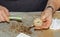 Cleaning a very dirty kitchen exhaust fan from dirt with a brush. A man cleans the parts of a fan with a brush