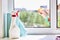 cleaning or washing dirty domestic window with a chemical spray. housework cleanup concept