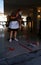 A cleaning worker wearing protective mask scrub the floor of a hotel entrance