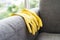 Cleaning yellow gloves on sofa. Hygiene service