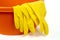 Cleanser brush and rubber gloves on white background