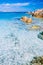 Clear amazing azure coloured sea water with gtanote rocks in Capriccioli beach, Sardinia, Italy