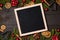Clear black felt letter board flatlay on dark rustic wood table with Christmas decoration and fir tree boarder. Top view with