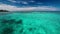 Clear blue lagoon with coral from moving boat, Maldives