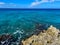 The clear blue ocean off of turtle reef in Cayman Islands on a beautiful blue sky day