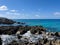 The clear blue ocean off of turtle reef in Cayman Islands on a beautiful blue sky day