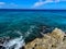 The clear blue ocean off of turtle reef in Cayman Islands on a beautiful blue sky day