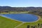 Clear blue reservoir set in the hills in North Island, New Zealand