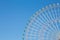 Clear blue sky over funfair ferris wheel