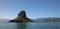 Clear blue sky over Mokolii island [also known as Chinamans Hat] as seen from the water on the North Shore of Oahu Hawaii USA