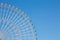 Clear blue sky over path of big ferris wheel