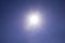 Clear blue sky sun light with Real Lens flare out of focus