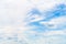 Clear blue sky on sunny day with sparse clouds, abstract background. Nature, air travel, weather forecast, cloudscape, or freedom